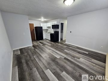 Saint Charles apartment for rent - A kitchen area with a black refrigerator and white cabinets.