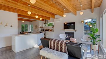 Portland apartment for rent - A living room with a white couch and a wooden ceiling.