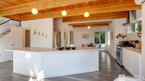 Portland apartment for rent - A kitchen with white cabinets and a wooden ceiling.