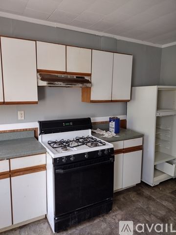Troy apartment for rent - A kitchen with white cabinets and a stove top oven.