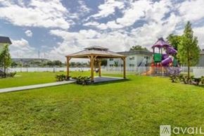 Miami Gardens apartment for rent - A backyard with a playground and a gazebo.