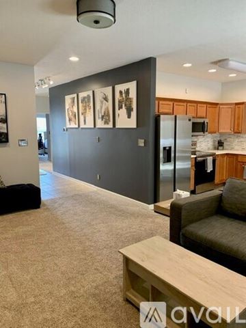 Indianapolis house for rent - A living room with a grey couch and a wooden coffee table.