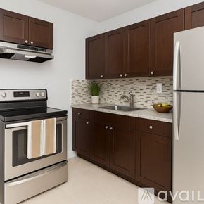 Miami Gardens apartment for rent - A kitchen with a stove, sink, and refrigerator.