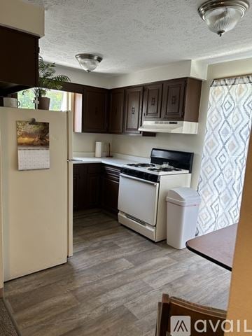 Massillon apartment for rent - A kitchen with a white refrigerator and a white stove top oven.
