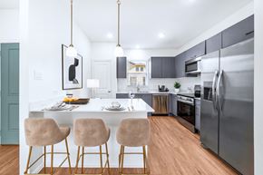 Greenville apartment for rent - A modern kitchen with a dining table and chairs.
