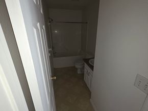 Monmouth apartment for rent - A small bathroom with a toilet, sink, and shower.