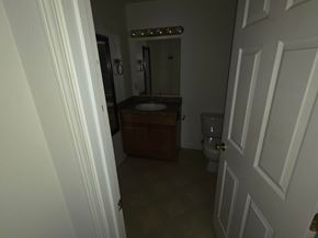 Monmouth apartment for rent - A bathroom with a toilet, sink, and mirror.