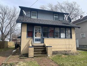 Akron house for rent - A house with a blue door and a satellite dish on the roof.
