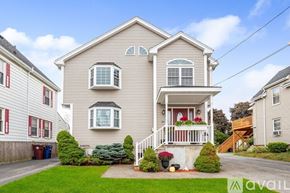 Revere townhouse for rent - A two-story house with a front porch and a garage.