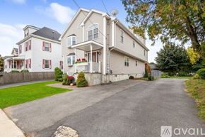 Revere townhouse for rent - A large house with a driveway in front of it.