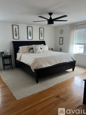 Revere townhouse for rent - A bedroom with a large bed and a ceiling fan.