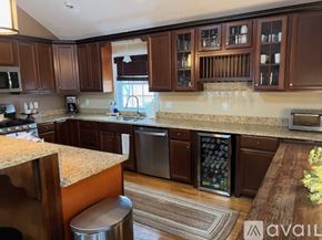 Revere townhouse for rent - A kitchen with brown cabinets and a granite countertop.