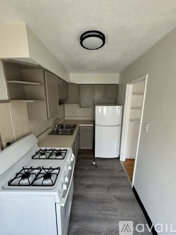 Hammond apartment for rent - A small kitchen with a white stove and a white refrigerator.