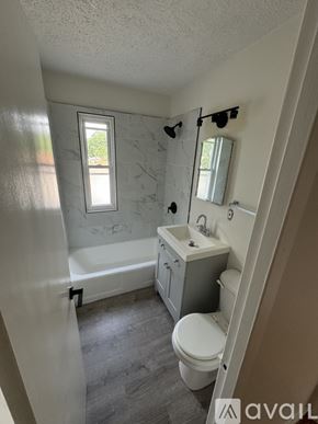 Hammond apartment for rent - A bathroom with a toilet, sink, and bathtub.