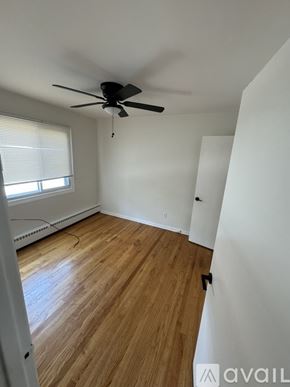Hammond apartment for rent - A room with a ceiling fan and wooden flooring.