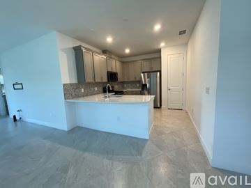 Parrish house for rent - A kitchen with a countertop and cabinets is available for rent.