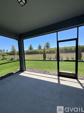 Parrish house for rent - A room with a large window overlooking a grassy field.