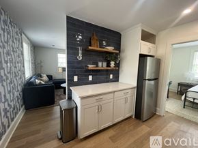 Charlottesville apartment for rent - A kitchen with blue cabinets and a stove top oven.