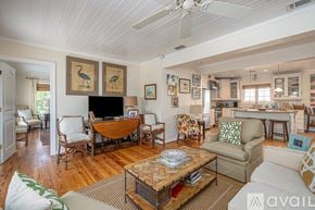 Tybee Island house for rent - A living room with a wooden floor and furniture.