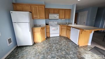 Lincoln City apartment for rent - A kitchen with a white refrigerator, white oven, and white dishwasher.