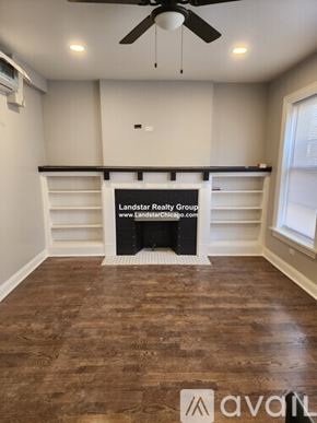 Chicago apartment for rent - A room with a wooden floor and a fan on the ceiling.