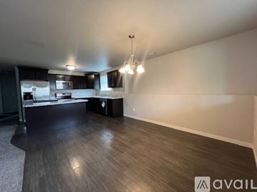 Rapid City apartment for rent - A kitchen with a refrigerator, microwave, and oven.
