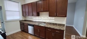 Chicago apartment for rent - A kitchen with brown cabinets and a countertop.