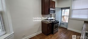 Chicago apartment for rent - A kitchen with wooden cabinets and a stainless steel oven.