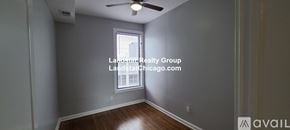 Chicago apartment for rent - A room with a window and a fan on the ceiling.