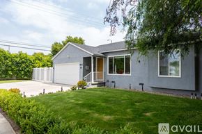 Los Angeles house for rent - A house with a grey exterior and a white garage door is for sale.