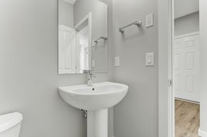 Spruce Grove apartment for rent - A white bathroom sink with a mirror above it.