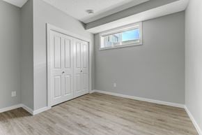 Spruce Grove apartment for rent - A room with a white door and a window with a view of a building outside.