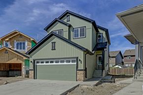 Spruce Grove apartment for rent - A two-story house with a garage is shown in the image.