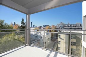 Seattle apartment for rent - A balcony with a view of a city skyline.