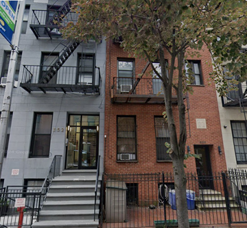 Brooklyn apartment for rent - A tree in front of a red brick building.