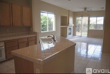 Folsom house for rent - A kitchen with a tile counter top and wooden cabinets.