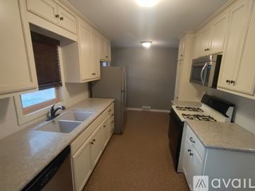 Blaine house for rent - A kitchen with white cabinets and a refrigerator.