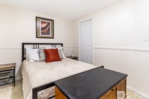 Hickory apartment for rent - A bedroom with a bed, nightstand, and a painting on the wall.