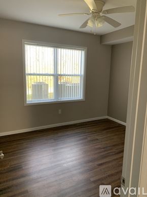 Cincinnati apartment for rent - A room with a window and a ceiling fan.