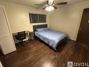 Houston house for rent - A bedroom with a bed, desk, and chair.