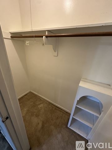 Houston house for rent - A white kitchen cabinet with a brown handle and a white shelf with a hole in the middle.