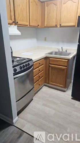 Chester apartment for rent - A kitchen with wooden cabinets and a stainless steel dishwasher.