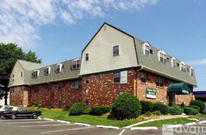 Chester apartment for rent - A building with a green awning and a sign that says "available" in front of it.