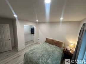 Hoquiam apartment for rent - A bedroom with a bed, nightstand, and lamp.