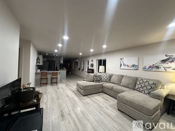 Hoquiam apartment for rent - A living room with a grey couch and a piano.