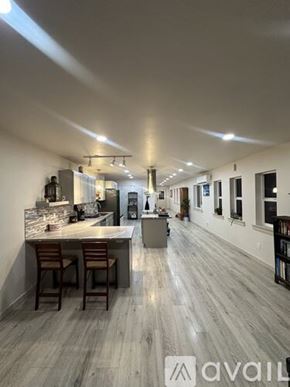 Hoquiam apartment for rent - A modern kitchen with a bar area and a dining area.