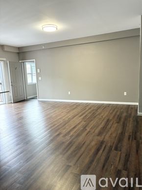 Cincinnati apartment for rent - A room with wooden flooring and a wall-mounted light fixture.