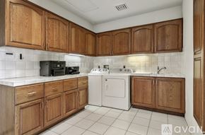 Indian Wells house for rent - A kitchen with wooden cabinets and white appliances.