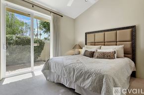 Indian Wells house for rent - A bedroom with a large bed and a sliding glass door.