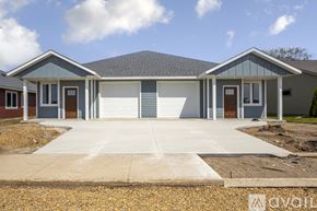 Saint Peter townhouse for rent - A house with a grey roof and a white garage door.